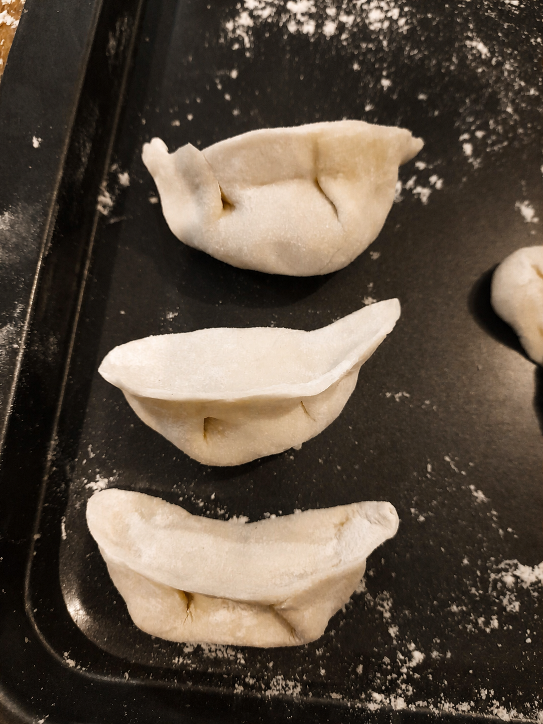 Handmade dumplings ready on a tray