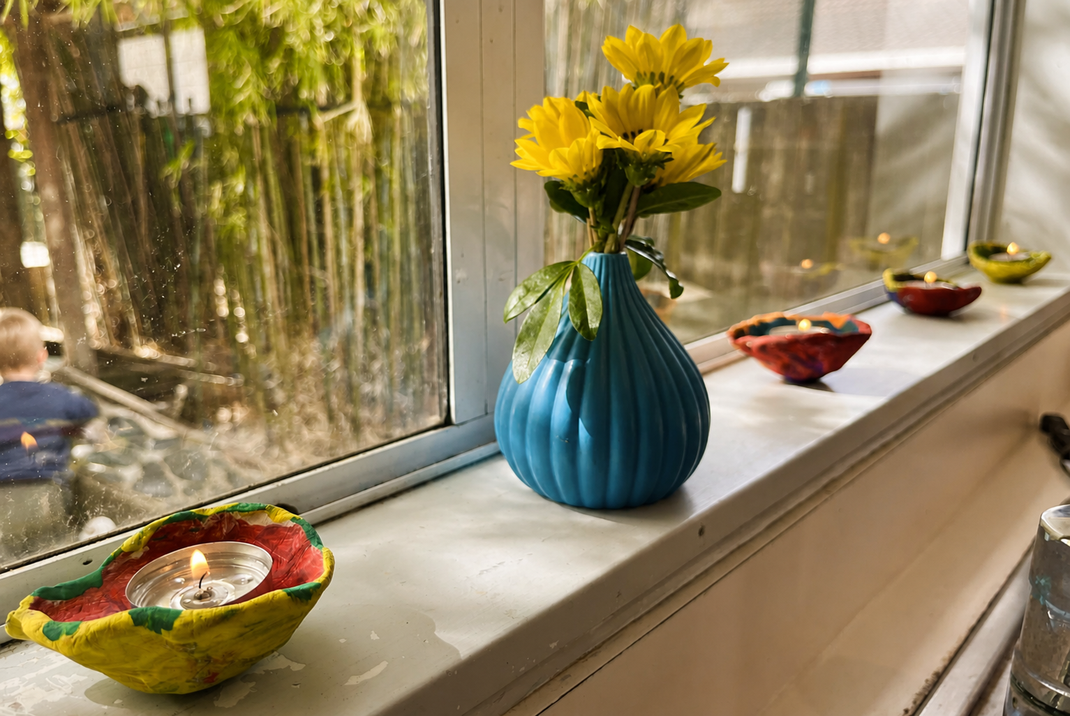 Diwali lamps and flowers on the Toddler Room windowsill