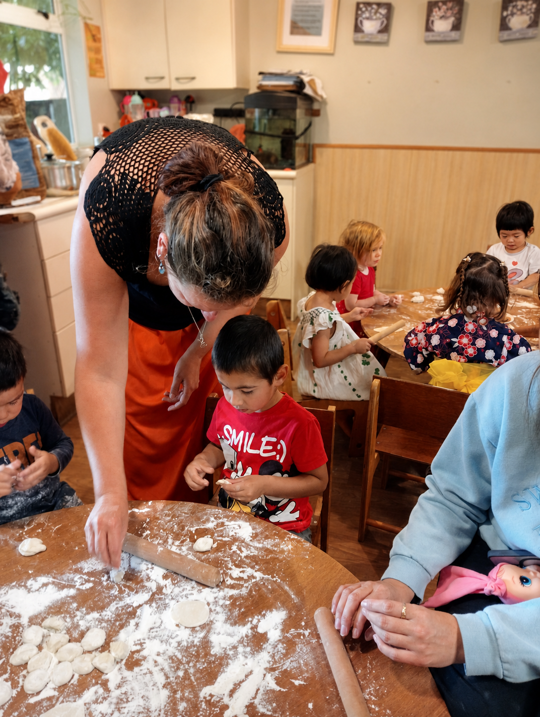 Children and a teacher preparing food together