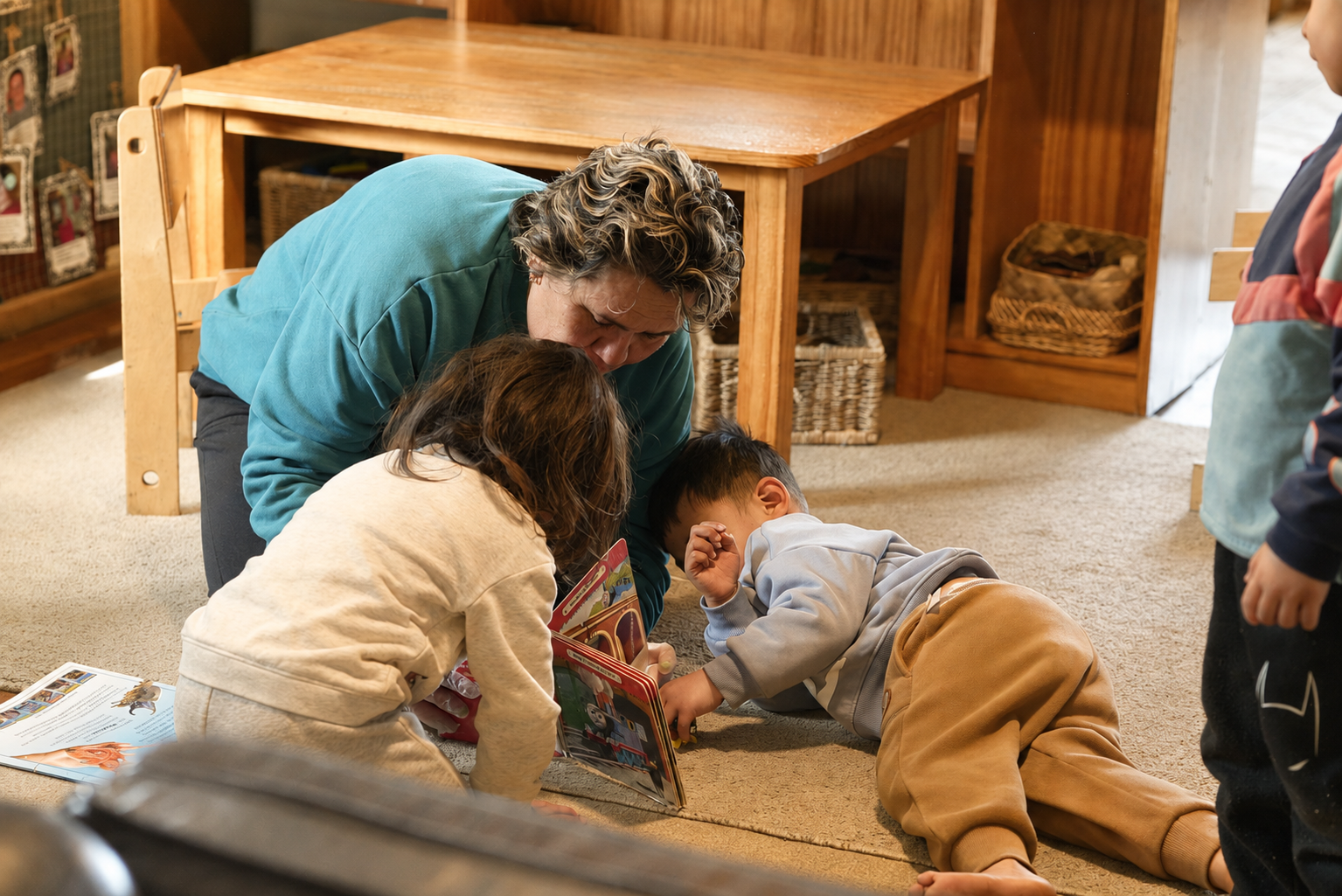 Teacher sharing a book with children at Royal Oak Learning Centre